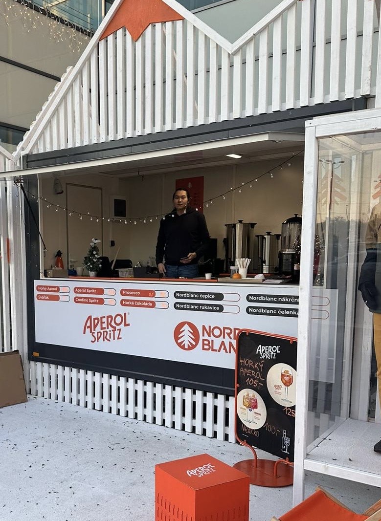 Serving window of a Gastro Přívěsy trailer branded for Aperol Spritz at an outdoor event